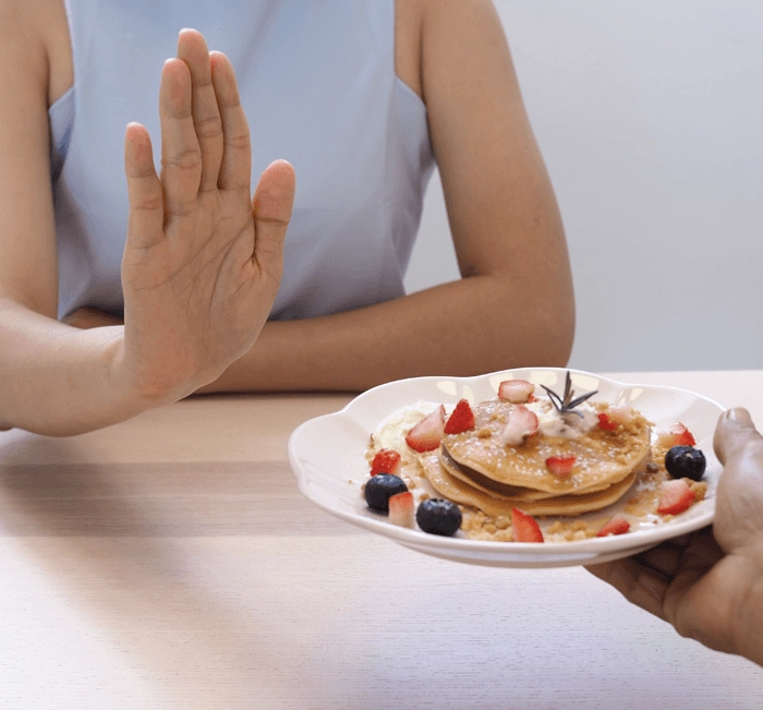 Turning down dessert to represent appetite suppression